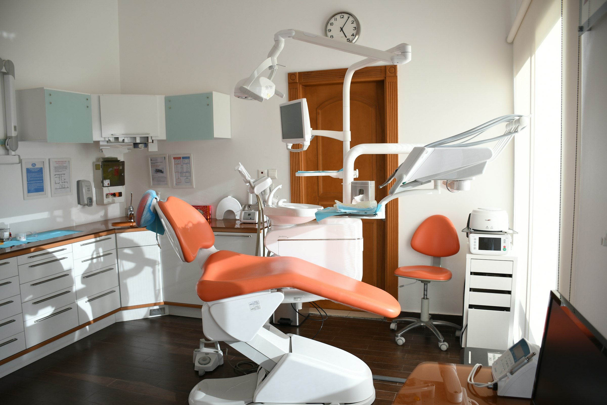 Pearl Dental Studio operatory with warm orange chairs